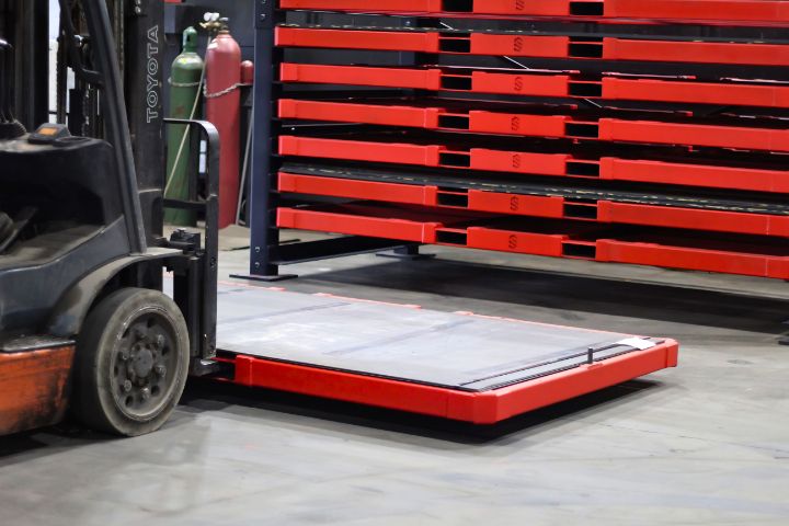 Forklift loading a sheet metal rack