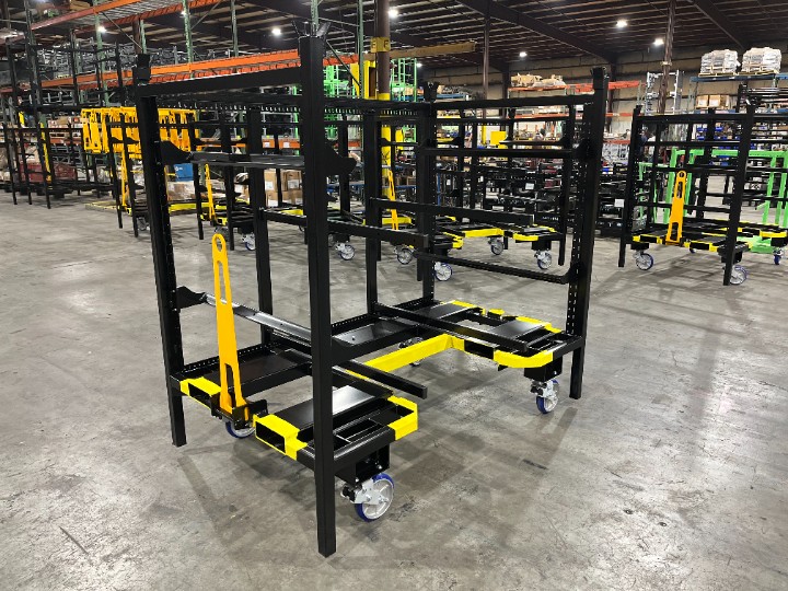 Black and yellow steel cart with a tow handle on a warehouse floor