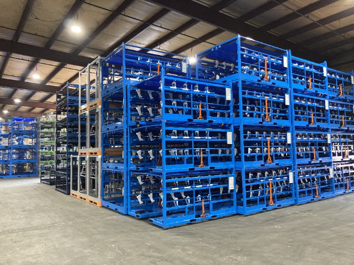 Stacked blue and gray shipping racks filling a warehouse