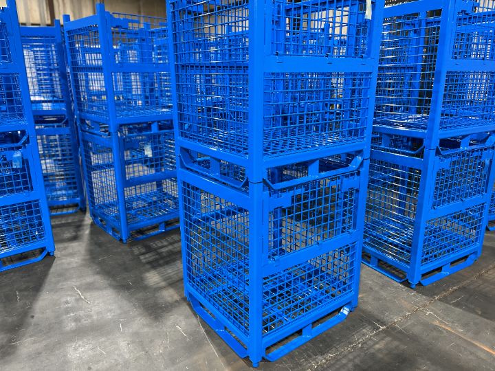 Stacked blue mesh steel containers on the shop floor