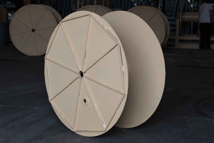 Large tan military cable reel on the shop floor