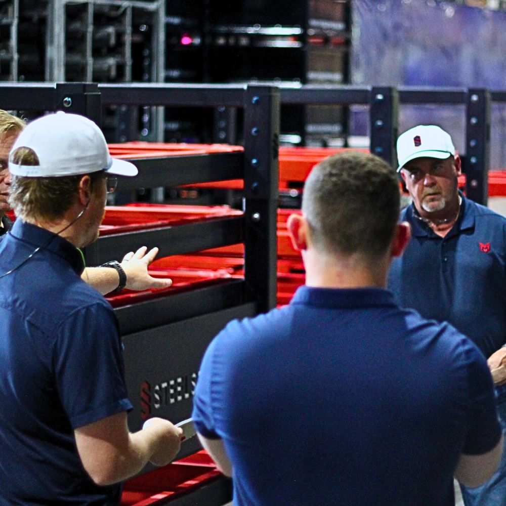Engineering and production team reviewing a fabricated rack on the shop floor
