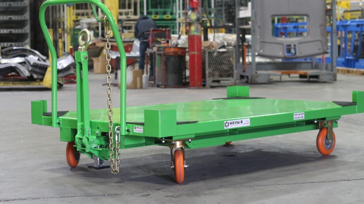 Green platform cart with tow handle and orange casters