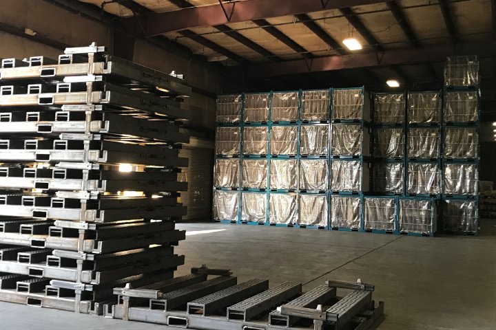 Portable heavy-duty stack racks staged in the facility for shipment
