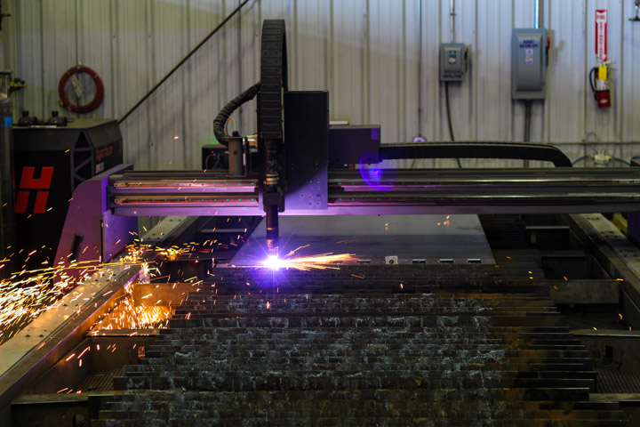 metal being cut by a purple laser
