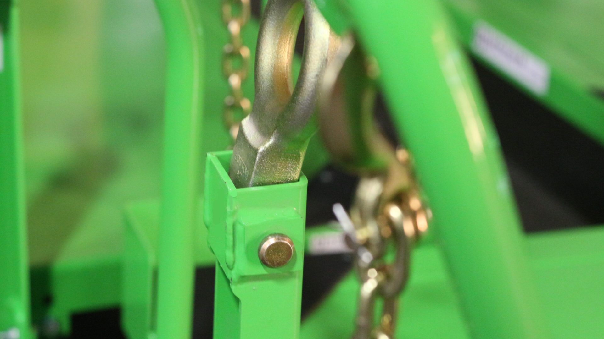 Custom green industrial dolly built for heavy-duty material transport across tight factory aisles.