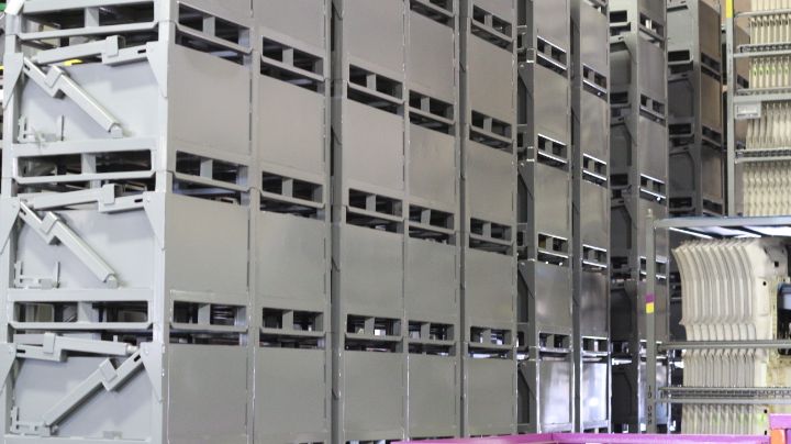 Gray custom industrial metal containers built for heavy-duty bulk storage and returnable shipping programs.