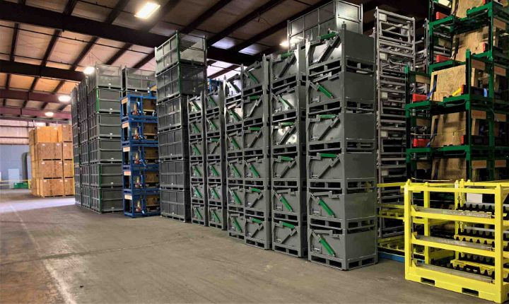 Rows of custom industrial metal containers staged on the shop floor, ready for shipment and fleet deployment.