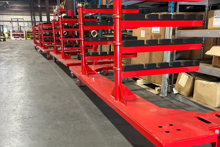 Red custom industrial shelf carts fabricated for multi-level parts transport and heavy-duty material handling.