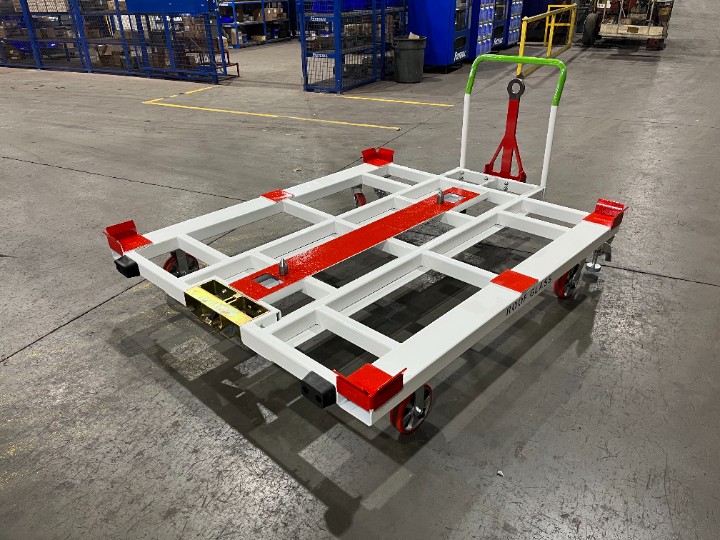 Custom white and red industrial material handling platform built for heavy-duty parts staging and transport.