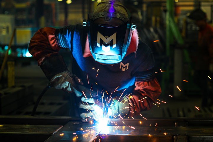 Welder fabricating a steel assembly