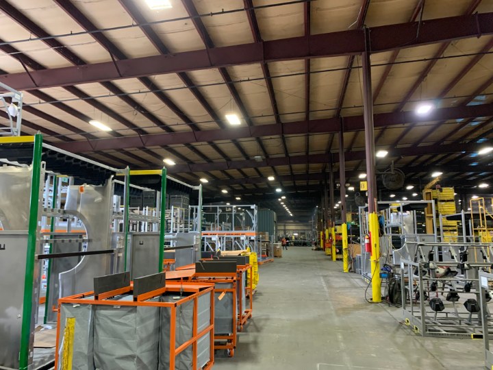 manufacturing floor with automotive racks and orange carts