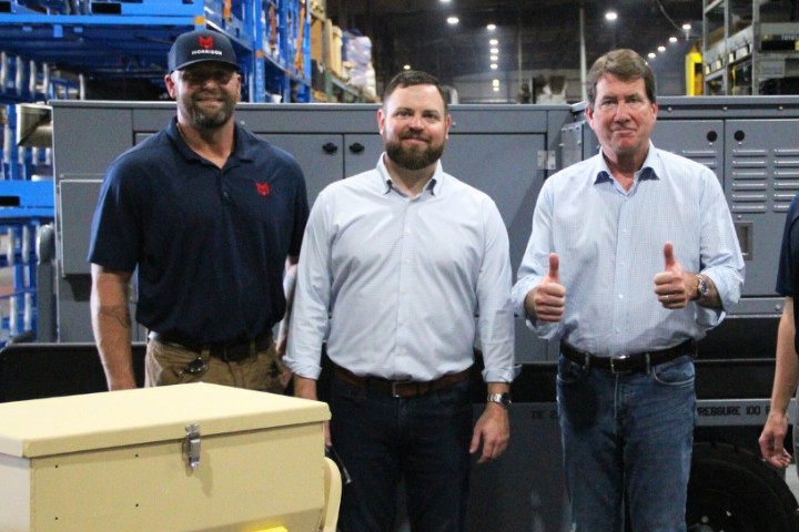 3 men in front of a metal product