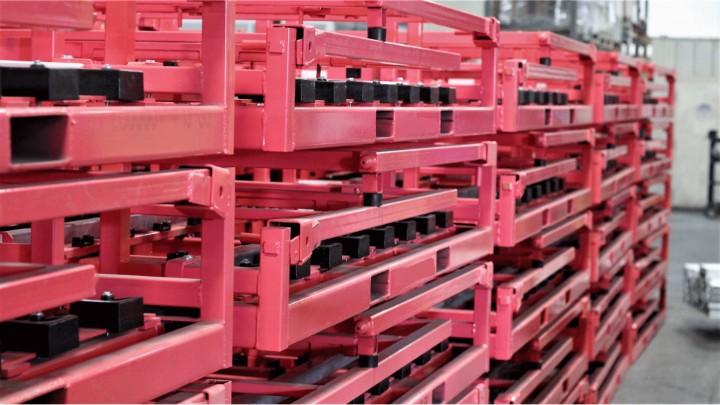 Pink collapsible stack racks staged for shipment