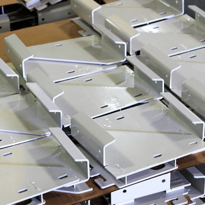 Laser-cut and press-brake-bent sheet metal parts ready for welding and assembly on the shop floor.