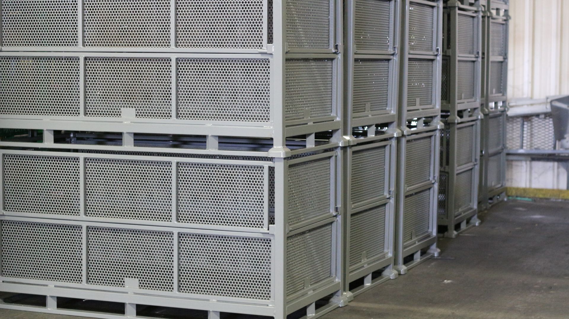 Stackable custom metal bins engineered for bulk parts storage, forklift handling, and returnable fleet duty.