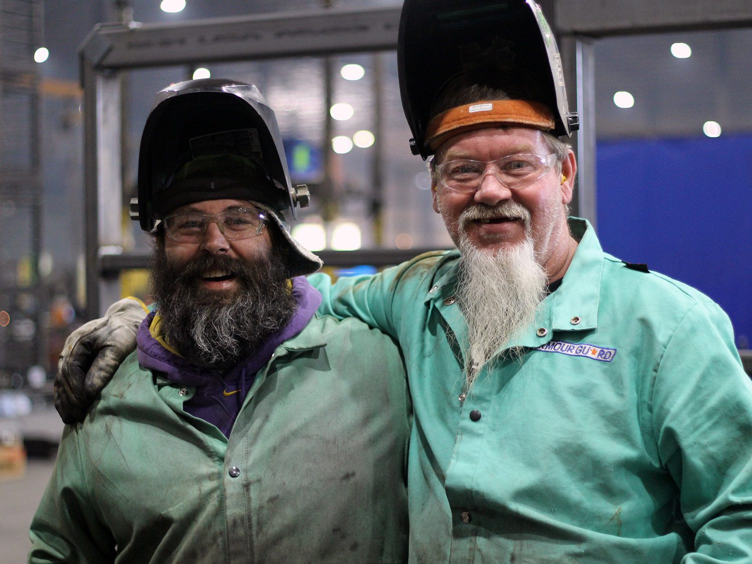 Welders smile for a photo during a break
